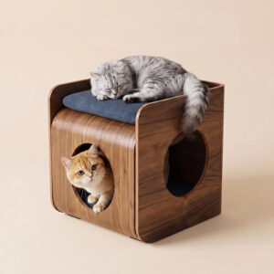 Walnut cat house stool with dual circular entry cutouts on front and side, navy blue seat cushion, a grey tabby cat sleeping on top and a ginger tabby cat peeking out from the front opening