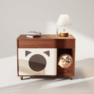 Dark walnut litter box cabinet with cat-ear graphic door, open cat nook, drawer, and caster wheels, styled as a bedside table with lamp and books, a fluffy ragdoll cat resting inside