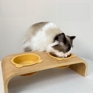 Ragdoll cat eating from an ergonomic solid wood cat bowl with dual silicone bowls